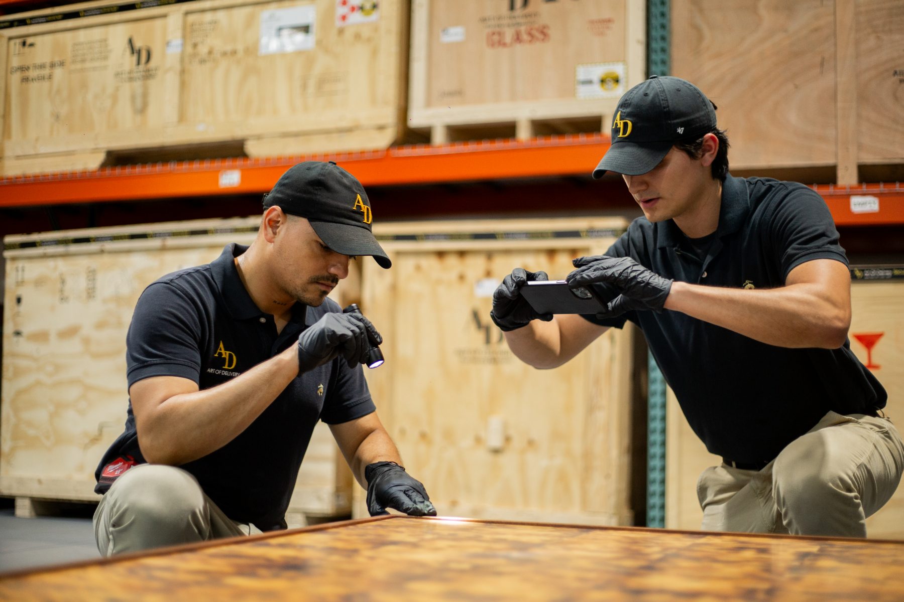 Two specialists inspecting and photo-documenting a table